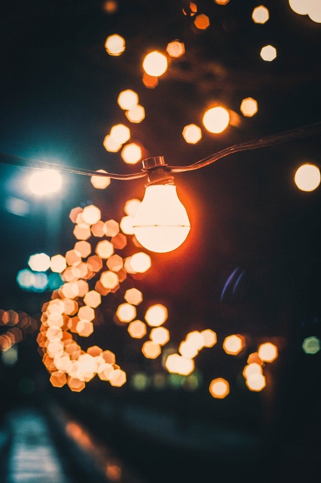 A bulb and string lights are displayed in a Houston outdoor lighting design