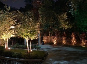 A driveway is lit up with outdoor security lights in Houston
