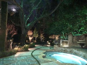Backyard lights brighten up a backyard's patio and pool