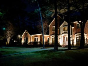 One of the popular lighting techniques, silhouetting, uses contrast to emphasize the shape of 3 trees in front of a house
