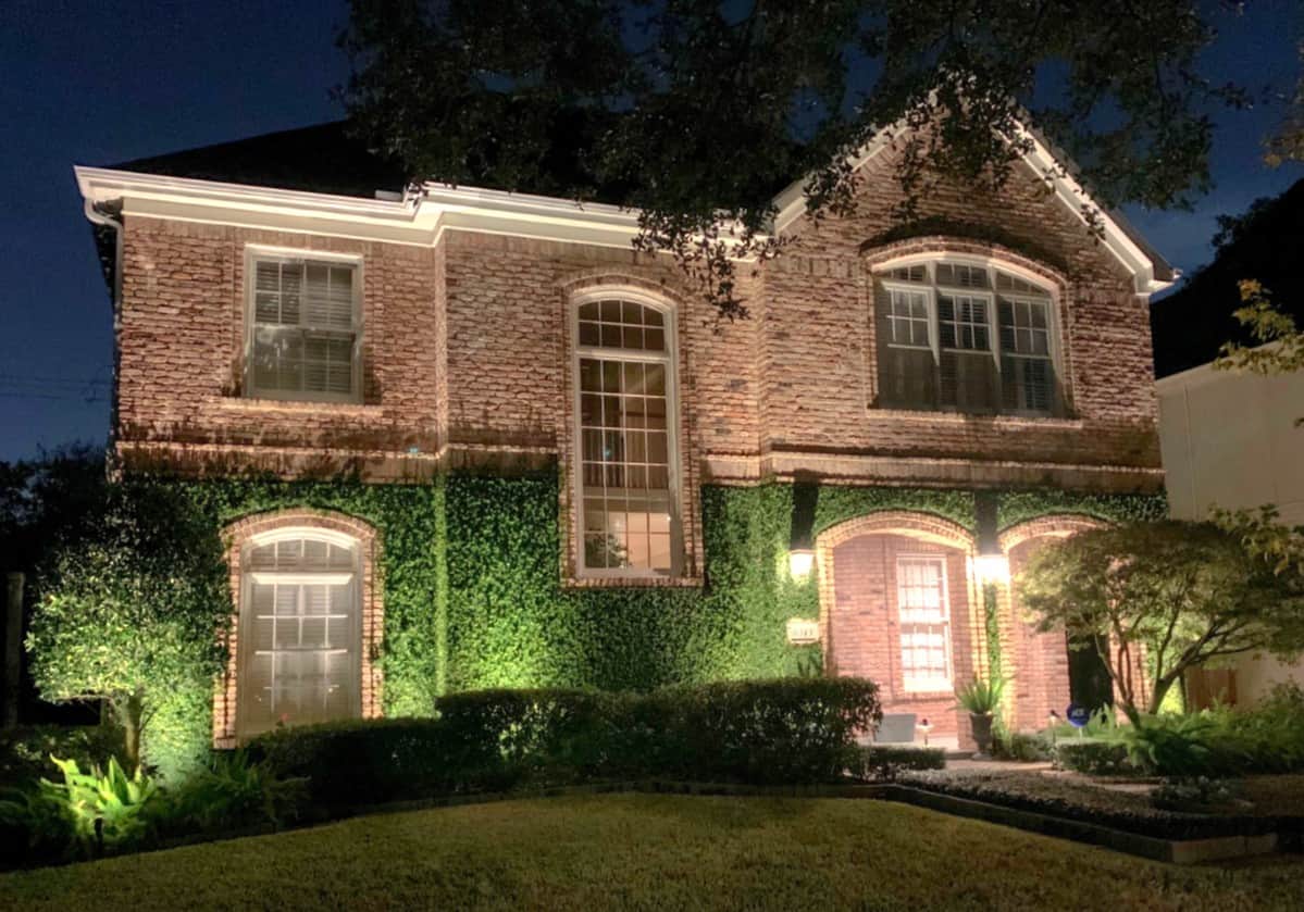 Wondering where to place landscape lighting? This brick house with ivy growing up the left side is a perfect example