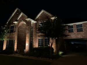 LED light maintenance was used to maintain this 2 story brick house with an archway