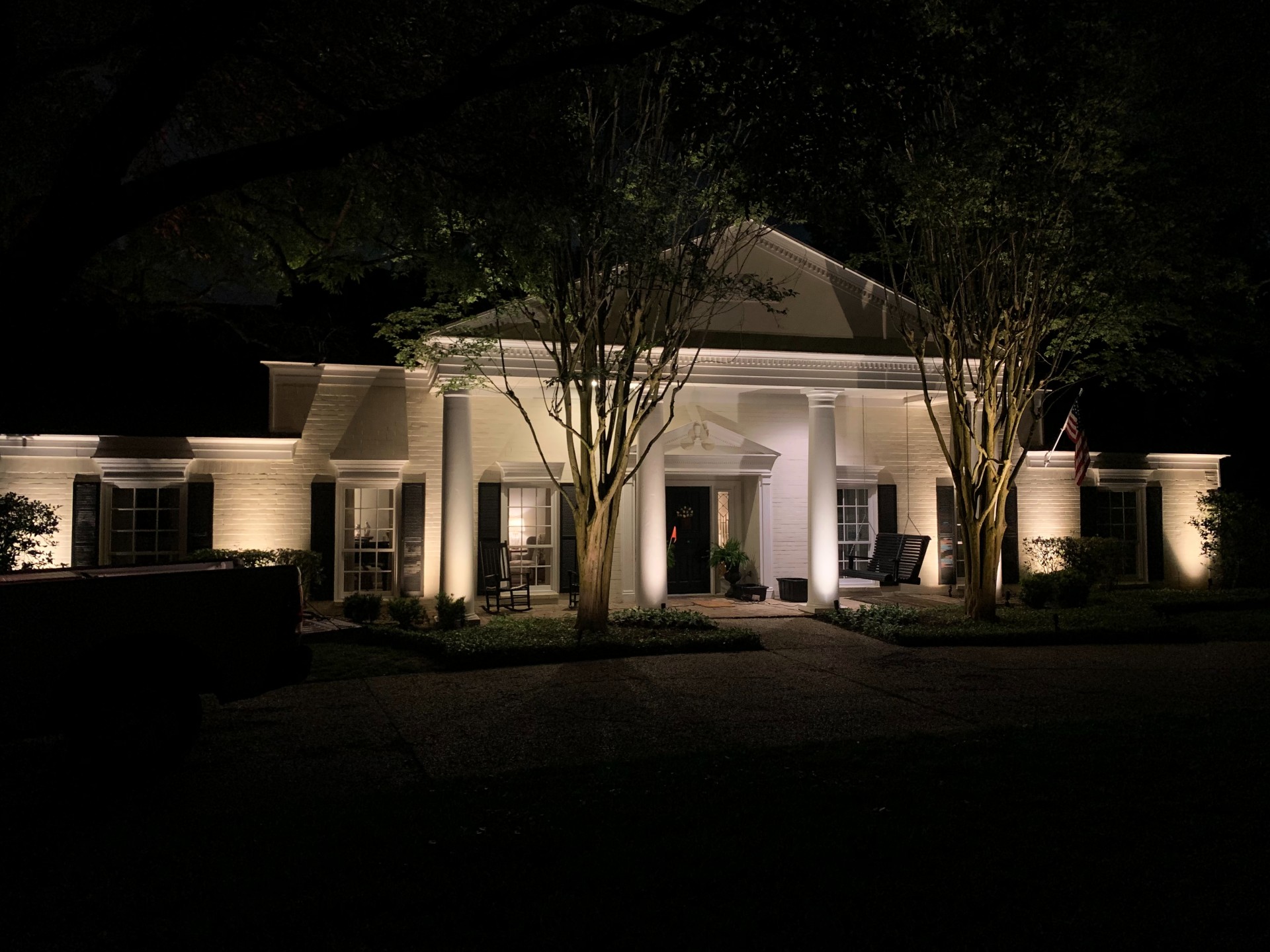Outdoor Lighting Highlights The Architectural Feature Columns of a home on a dark evening
