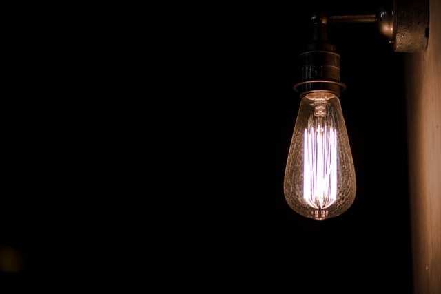 Single filament bulb illuminated at night