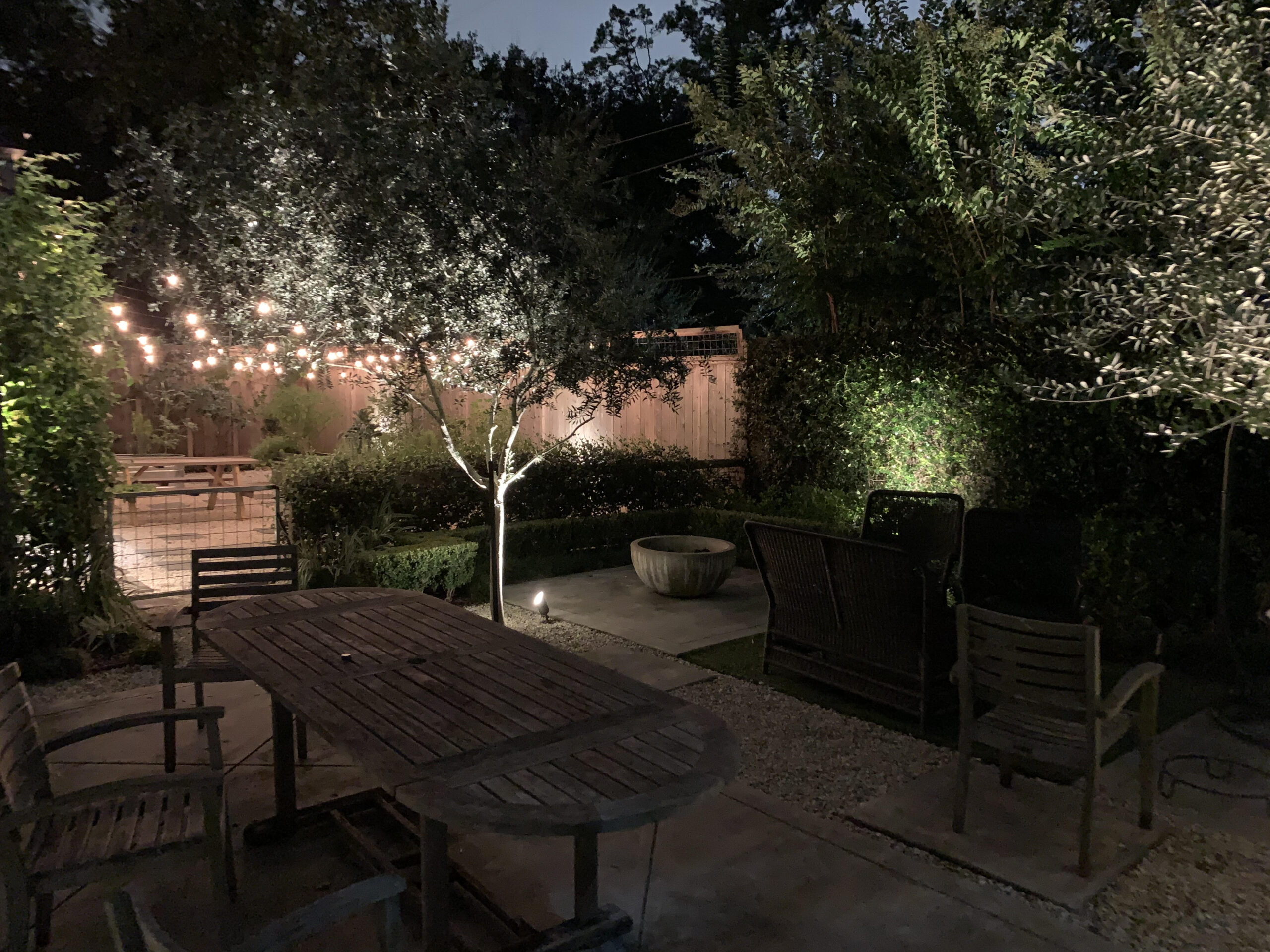 Illuminated landscape on patio of backyard at night
