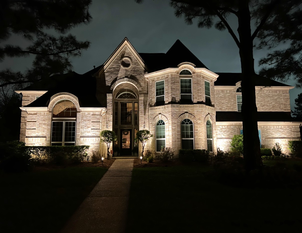 Bright Outdoor Lighting Illuminates the exterior of a brick home front