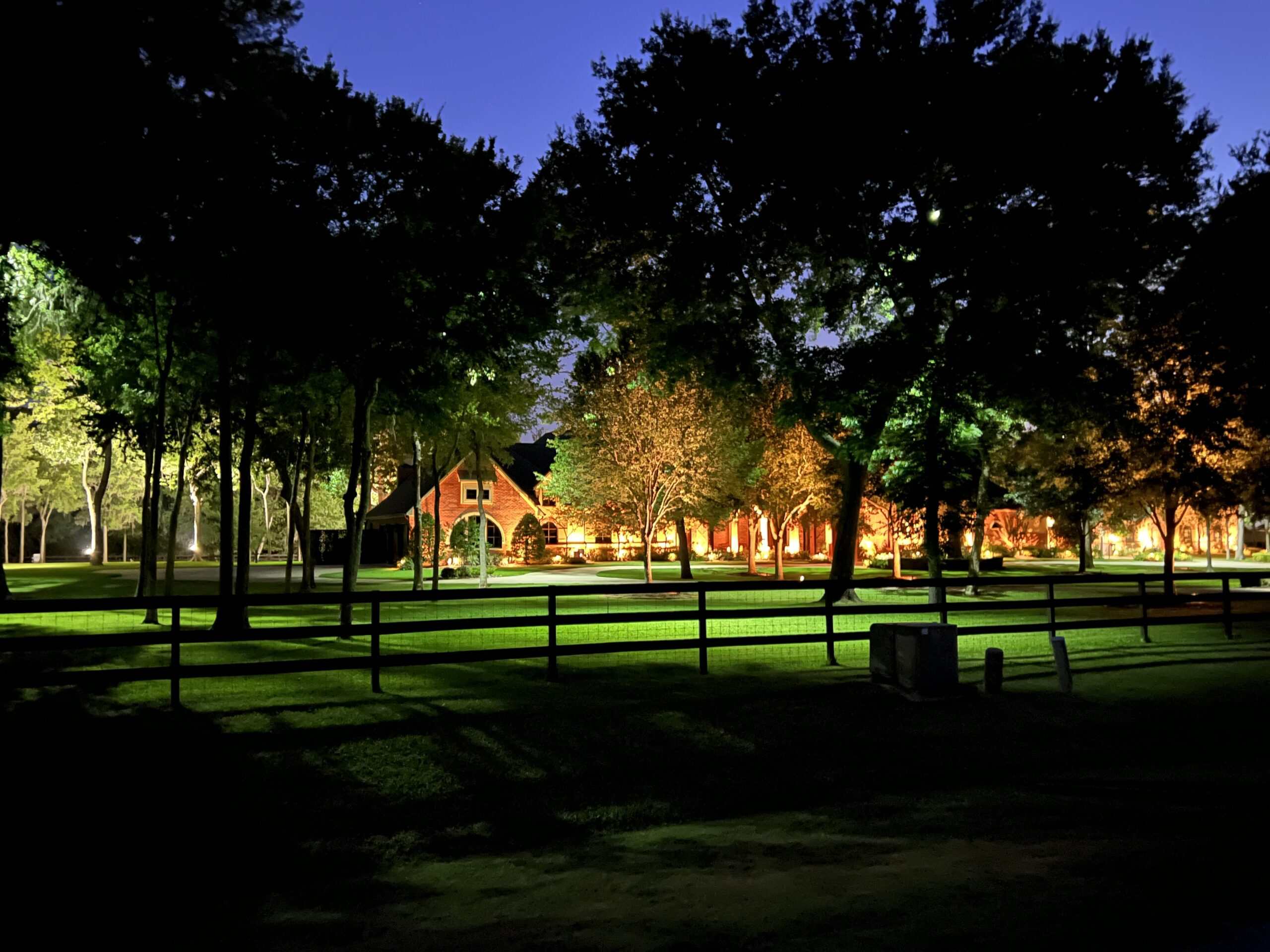 Large outdoor space, illuminated large front year with trees
