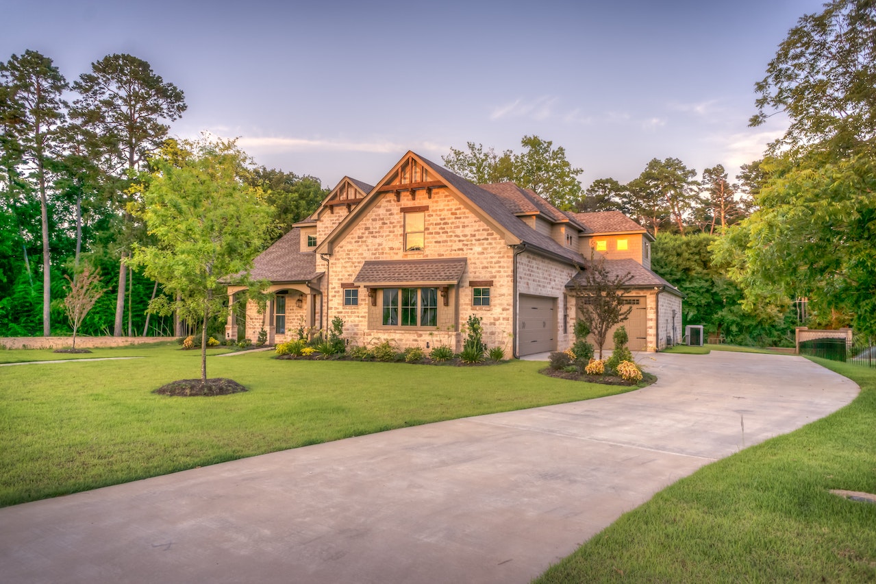 New home with trees & driveway needing outdoor lights