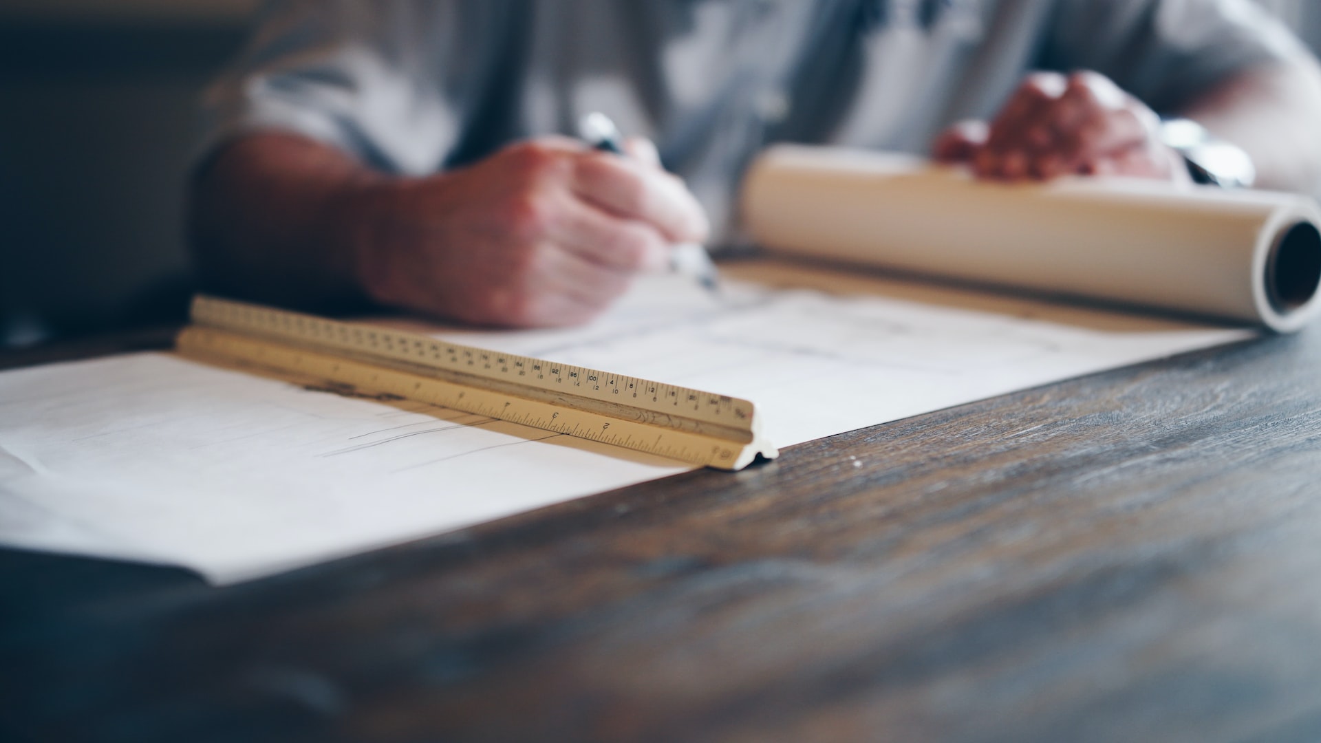 Drawing up a plan for landscape lighting at table with ruler