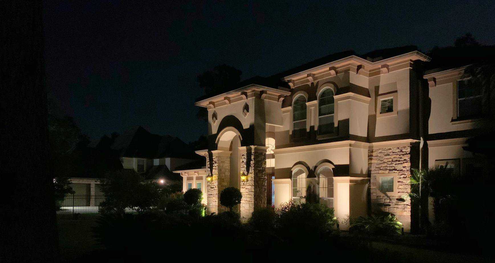 Wash lighting illuminates architecture front of home at night