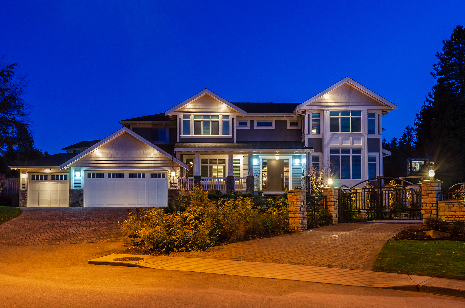 Large home with lighting on walkway and driveway, new year lighting trends