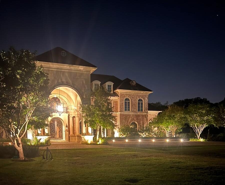Landscape and driveway lighting leading up to large well it home will increase value