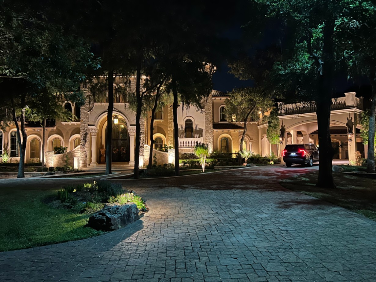 Large home and driveway with updated exterior lighting