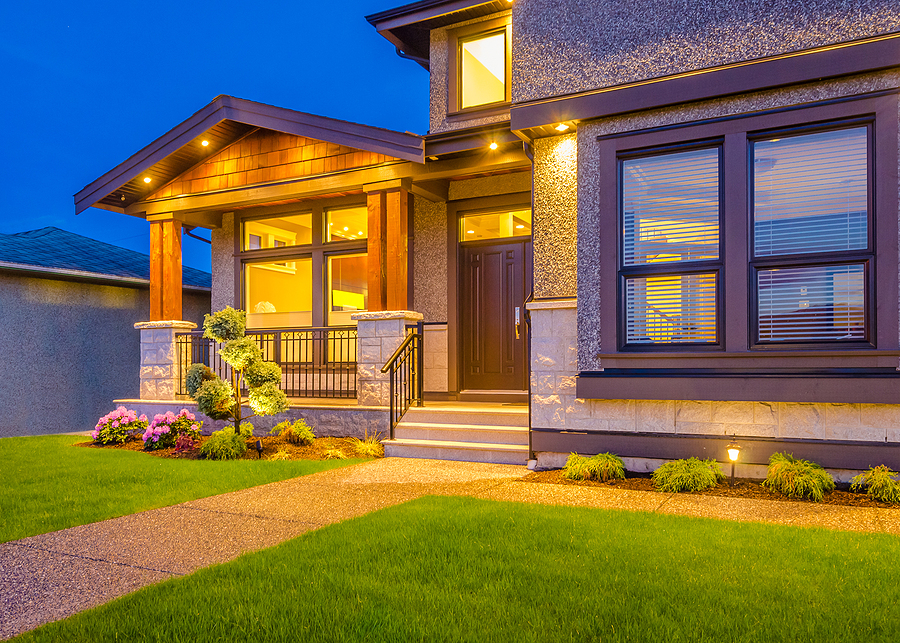 Luxury house at night in Vancouver, Canada. Adding outdoor lighting is one of the simplest ways to upgrade the look and function of your home no matter what your budget is.