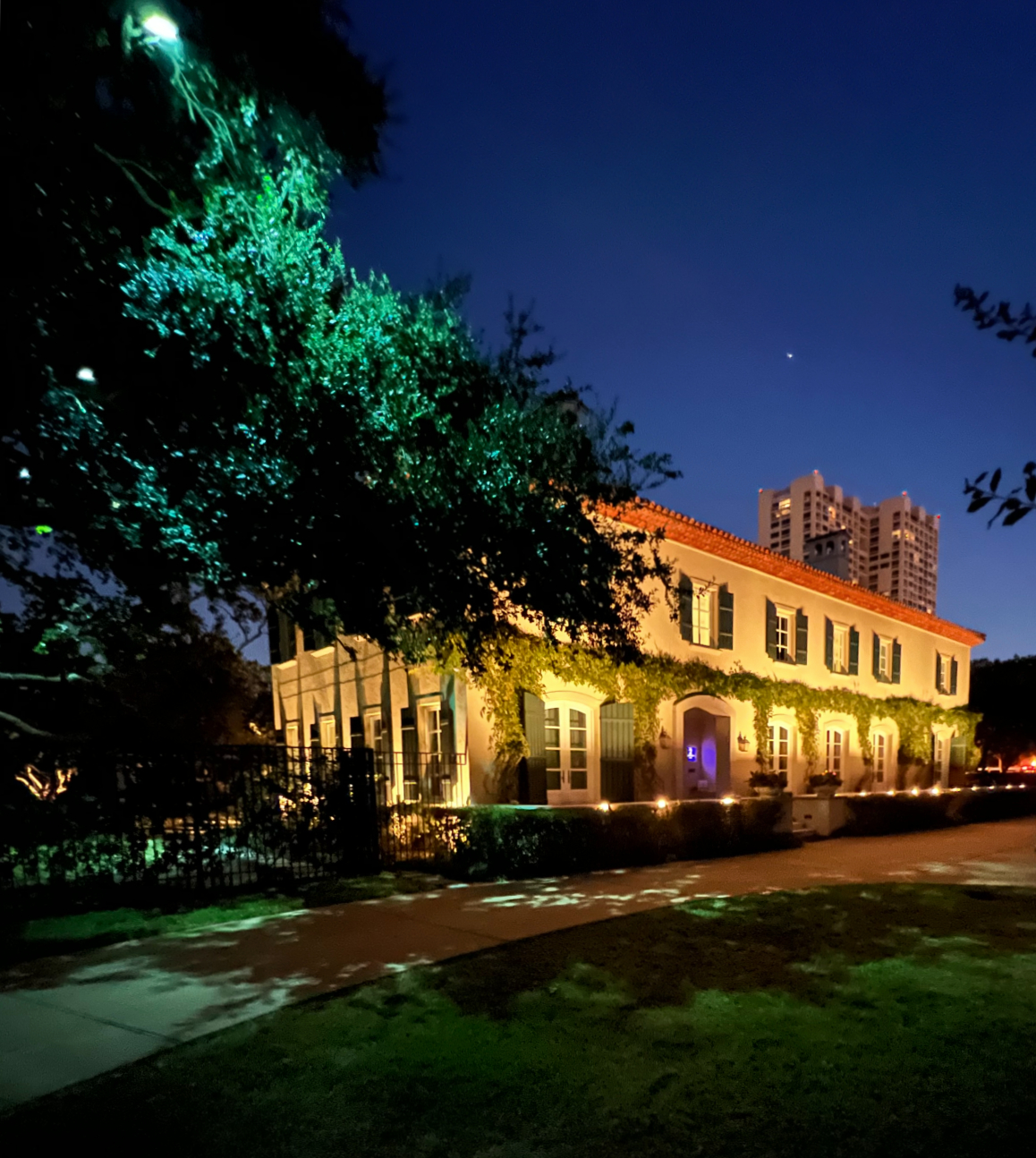 Front of home exterior at dusk highlighting what can be done with landscape lighting design.