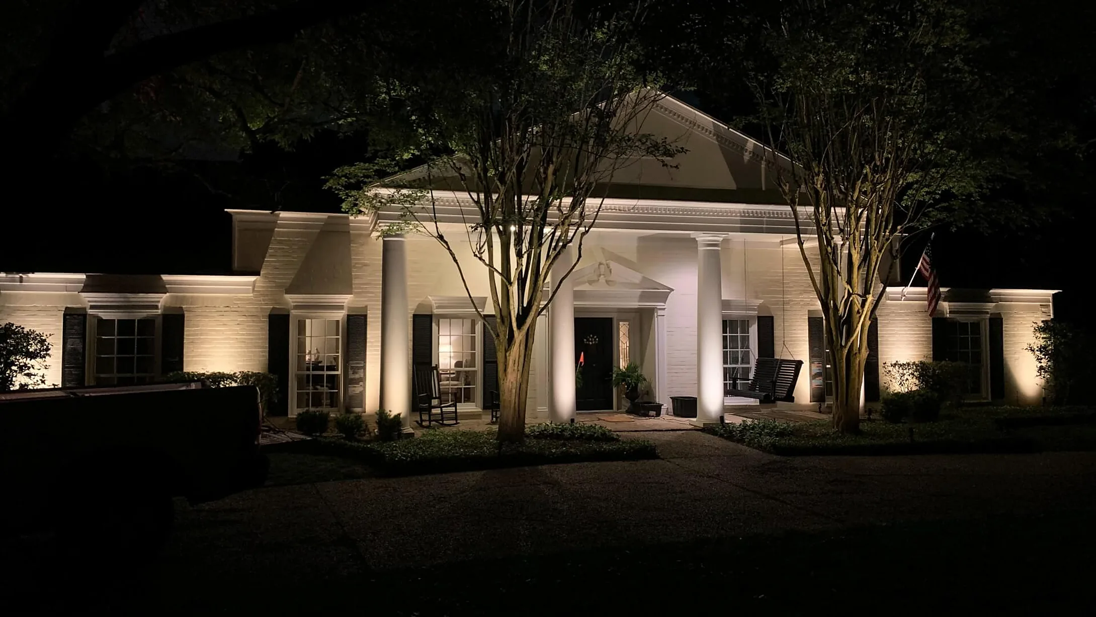 Commercial building and landscaping lit after dark