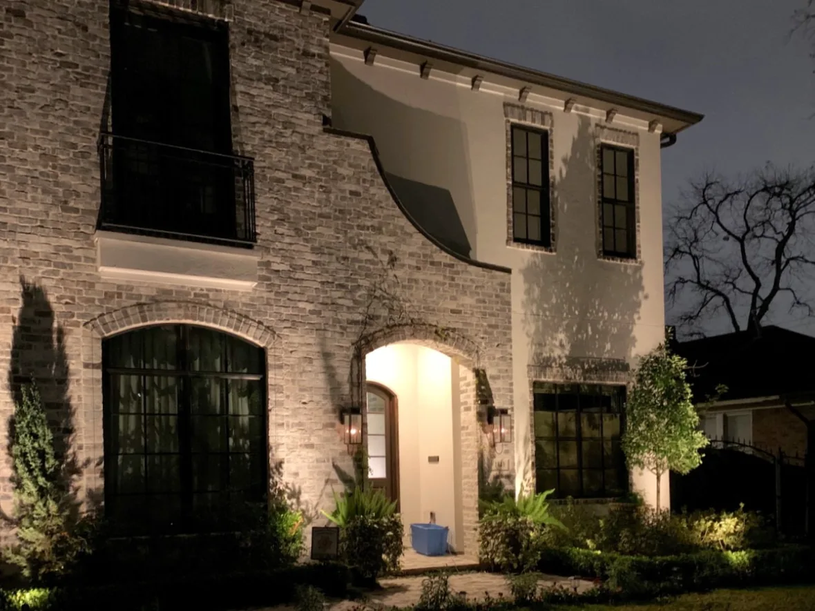 hl-arch-entry-arch-1180.webp Arched stone entry lit so the doorway is the brightest point of the elevation