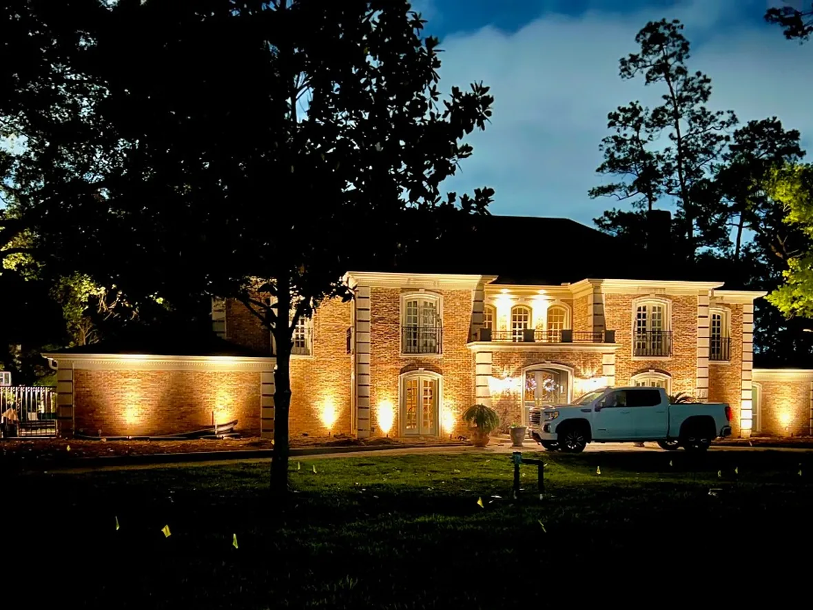 Completed lighting system reviewed after dark, with fixture angles being checked across the elevation