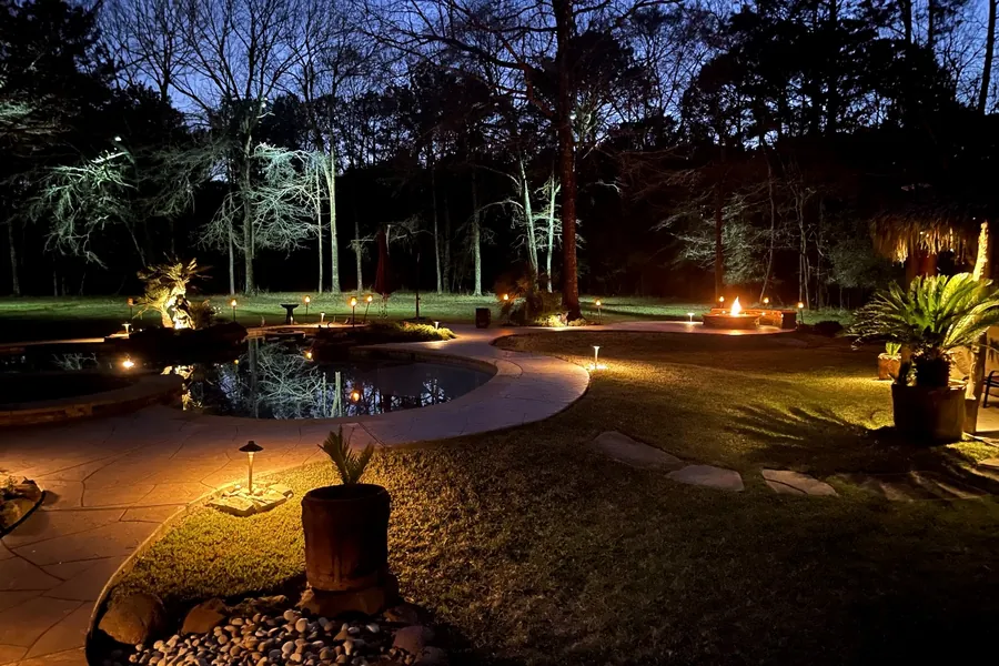 Backyard seating area and fire feature lit to extend the usable space after dark